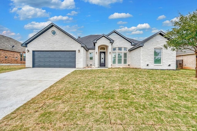 french provincial home with a front lawn and a garage