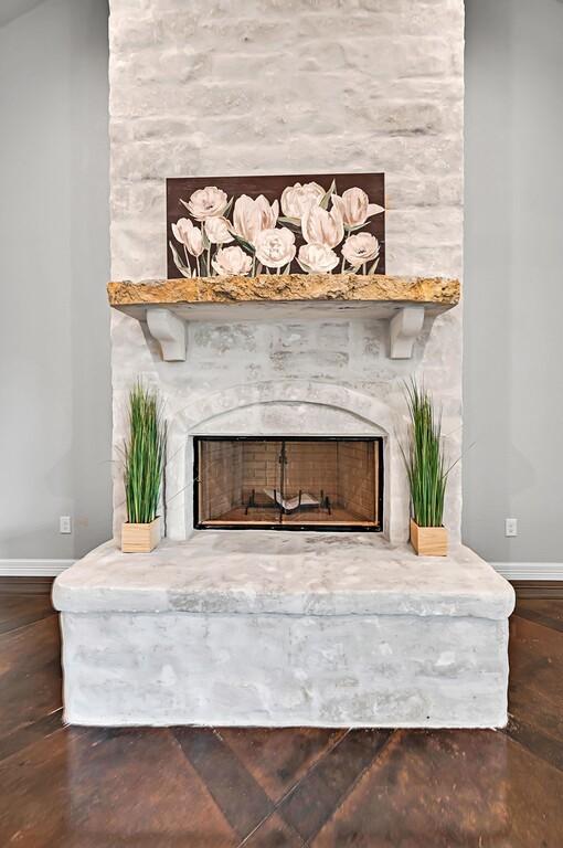 details with a fireplace and hardwood / wood-style flooring