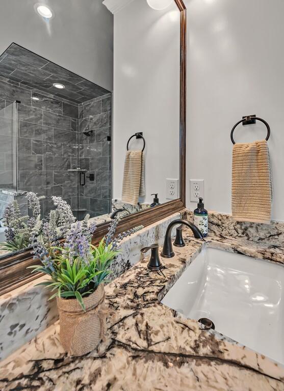 bathroom featuring vanity and a shower with shower door