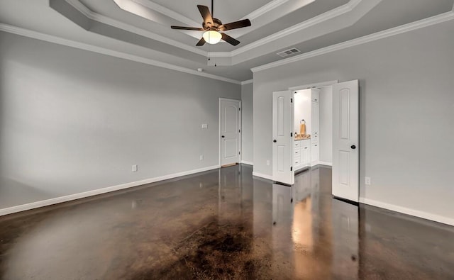 empty room featuring ceiling fan, a raised ceiling, and crown molding