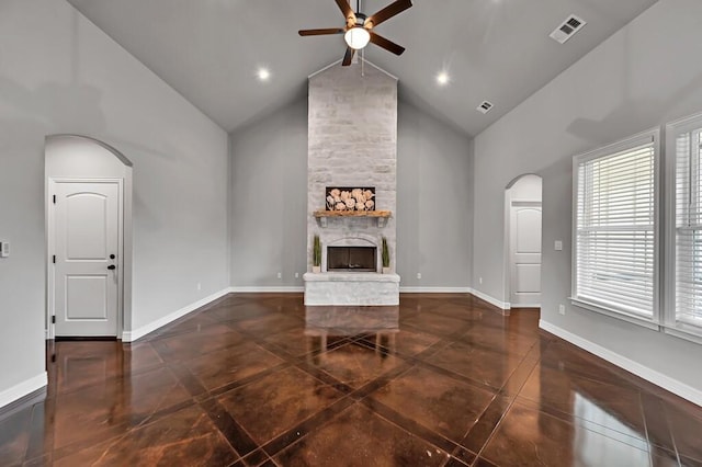 unfurnished living room featuring dark tile patterned floors, ceiling fan, a fireplace, and high vaulted ceiling