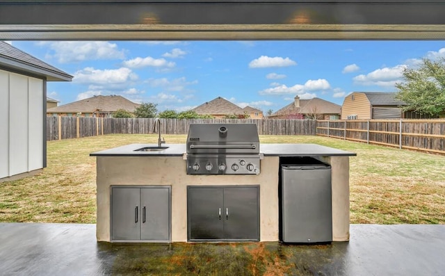 view of patio featuring area for grilling, sink, and an outdoor kitchen