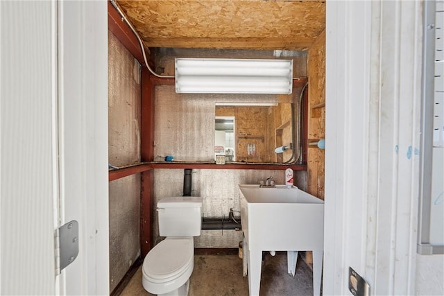 bathroom featuring toilet, concrete floors, and vanity