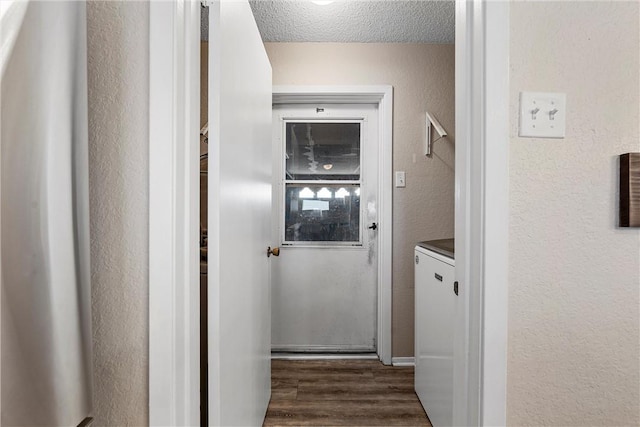 hall featuring a textured ceiling and dark hardwood / wood-style flooring