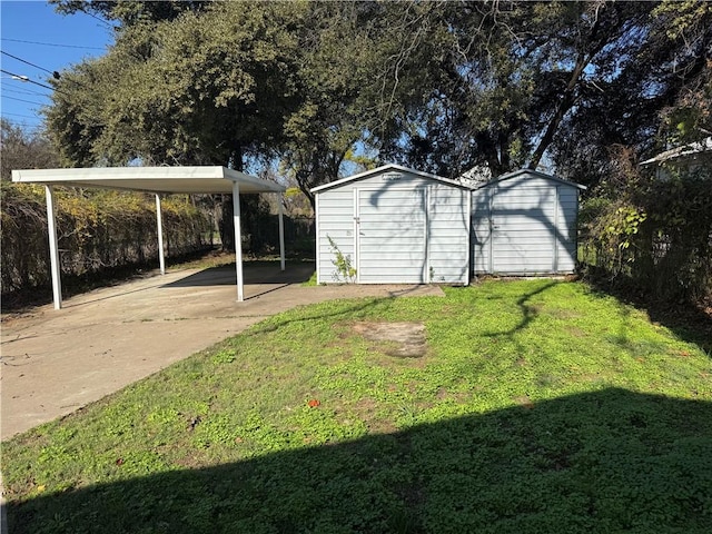 view of yard with a shed and a carport