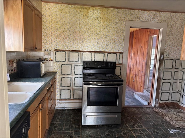 kitchen featuring ornamental molding, black dishwasher, stainless steel range with electric cooktop, and sink