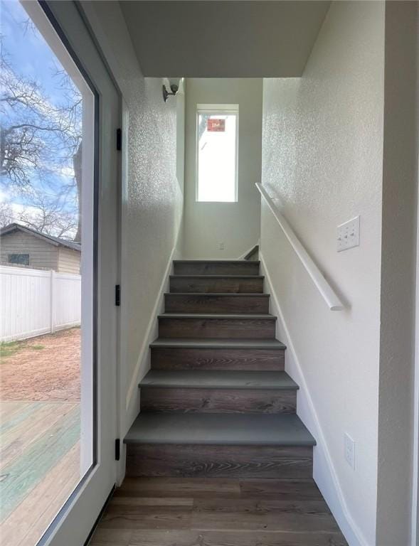 stairs featuring hardwood / wood-style floors