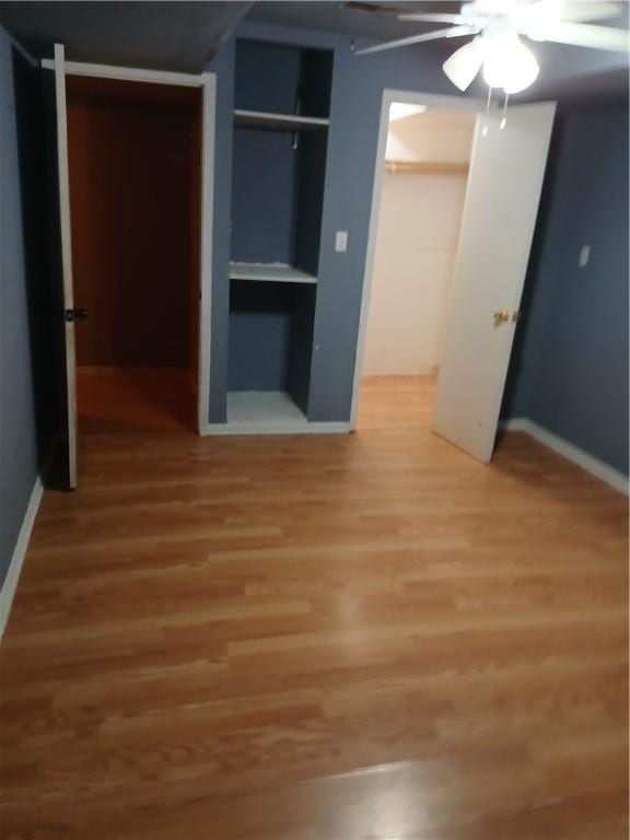 unfurnished bedroom featuring a closet, ceiling fan, and hardwood / wood-style floors