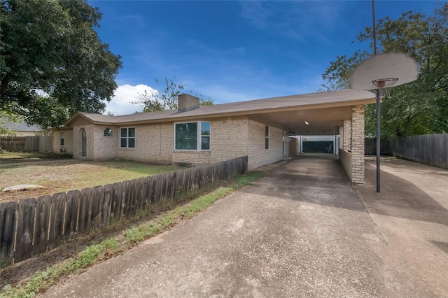 ranch-style home featuring a carport