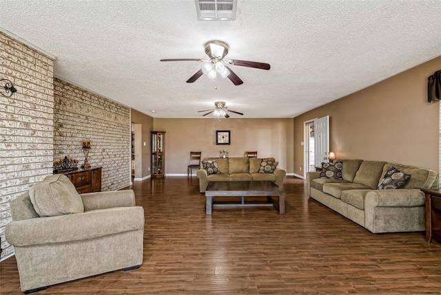 living room featuring dark hardwood / wood-style floors, ceiling fan, and a textured ceiling