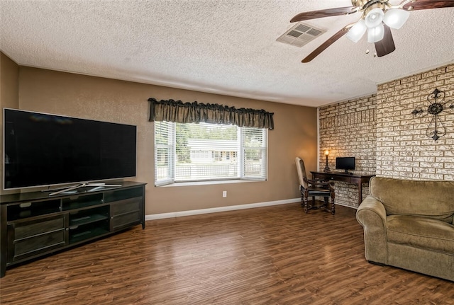 living room with a textured ceiling, ceiling fan, and dark hardwood / wood-style floors