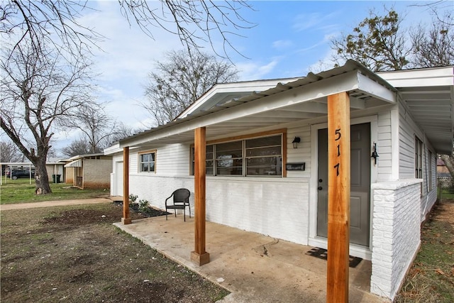 view of side of property with brick siding