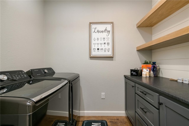 laundry room featuring washer and dryer and cabinets