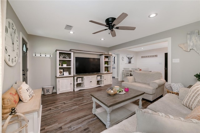 living room with dark hardwood / wood-style floors and ceiling fan