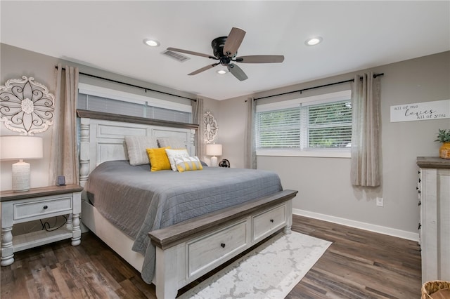 bedroom with dark hardwood / wood-style flooring and ceiling fan