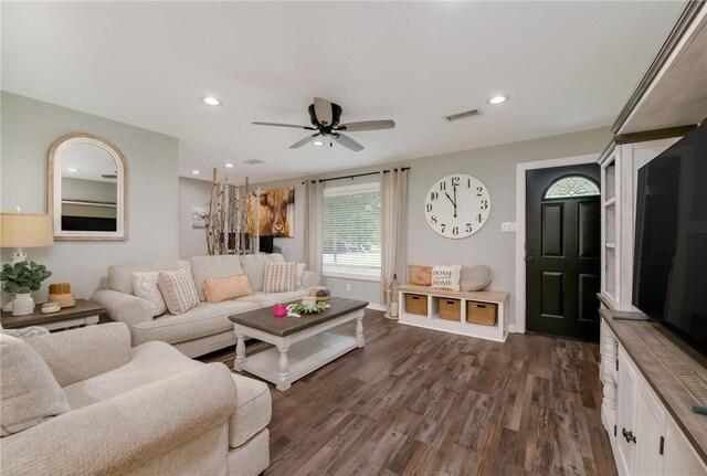 living room with dark hardwood / wood-style floors and ceiling fan