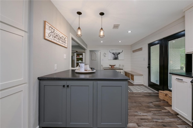 kitchen with gray cabinets, white cabinets, decorative light fixtures, and dark hardwood / wood-style floors