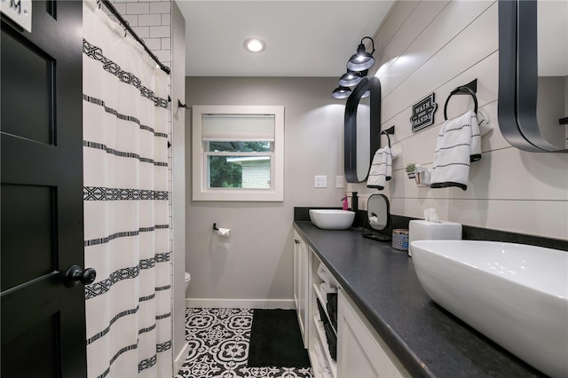 bathroom with tile patterned floors, vanity, and toilet