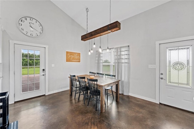 dining area with high vaulted ceiling