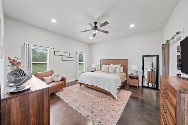 bedroom with a barn door and ceiling fan