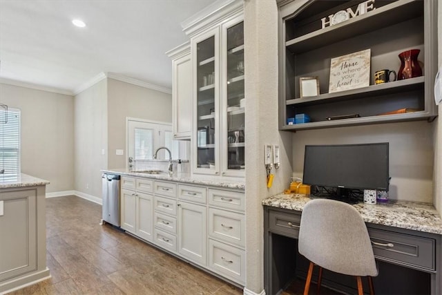 office area with hardwood / wood-style floors, built in desk, sink, and ornamental molding