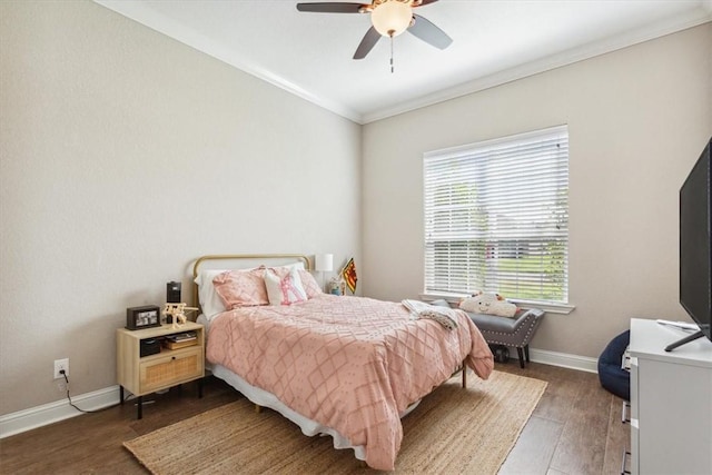 bedroom with ceiling fan, dark hardwood / wood-style flooring, and ornamental molding