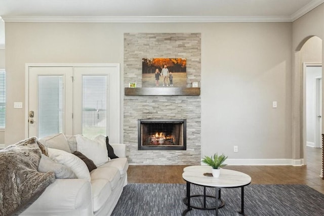 living room featuring a fireplace, dark hardwood / wood-style floors, and ornamental molding