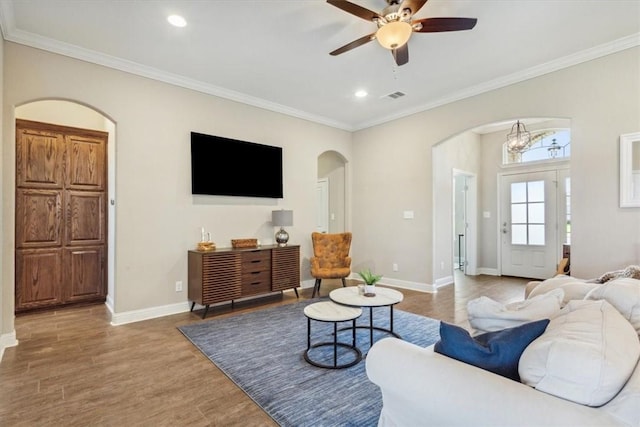 living room with crown molding, hardwood / wood-style floors, and ceiling fan