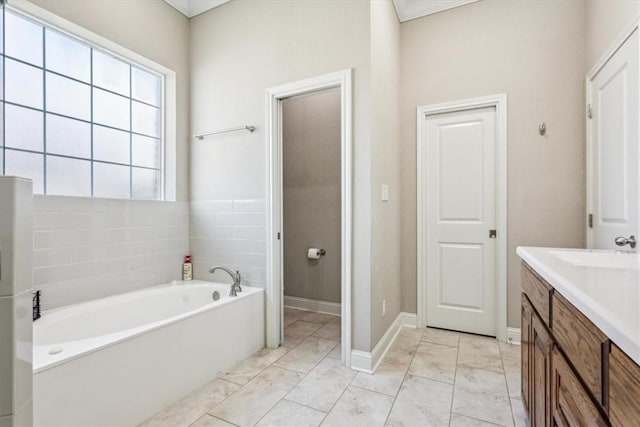 bathroom featuring a washtub and vanity