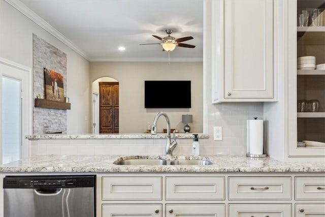 kitchen with white cabinetry, sink, stainless steel dishwasher, and light stone counters