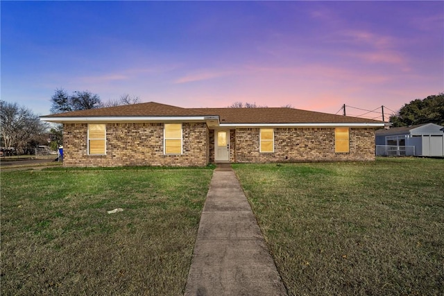 single story home featuring a lawn