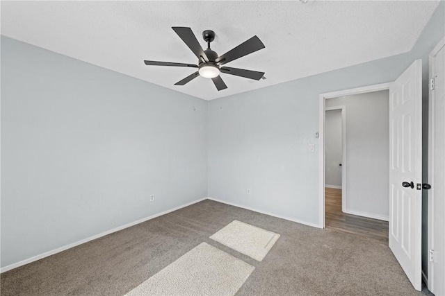 empty room with carpet, a textured ceiling, and ceiling fan