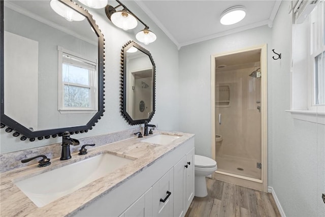 bathroom with walk in shower, crown molding, toilet, vanity, and hardwood / wood-style flooring