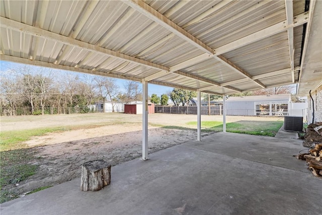 view of patio / terrace with a shed and central AC unit