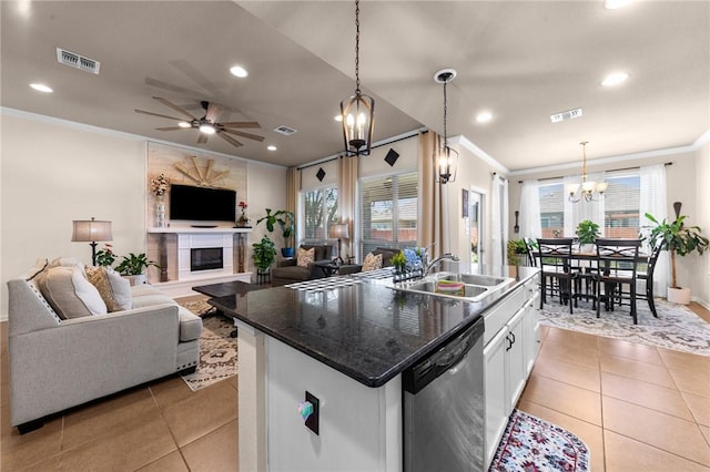 kitchen featuring a center island with sink, dishwasher, open floor plan, hanging light fixtures, and white cabinetry