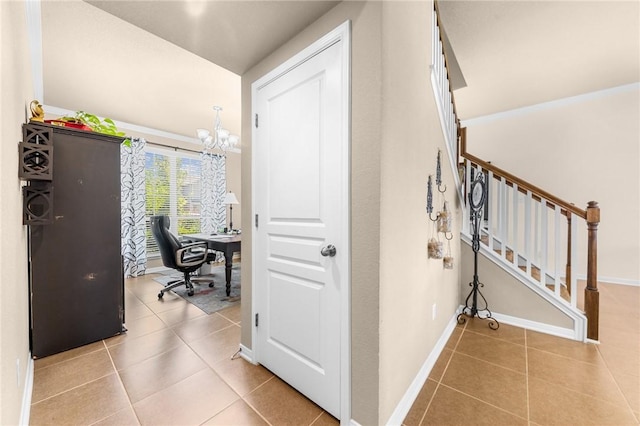 corridor with a notable chandelier, stairway, baseboards, and light tile patterned floors