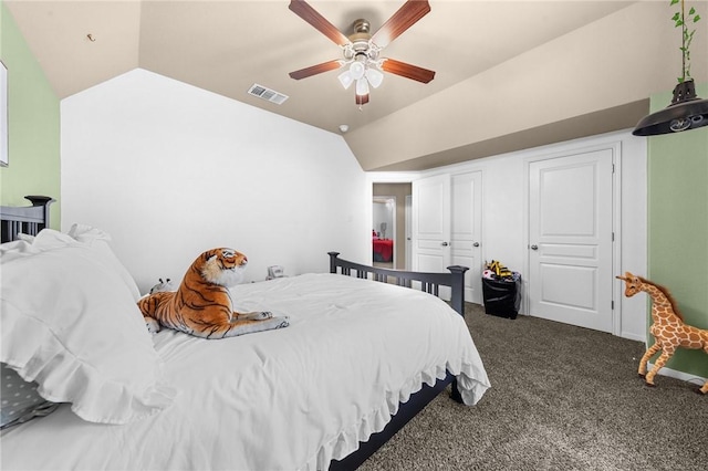 bedroom with dark carpet, visible vents, vaulted ceiling, and a ceiling fan