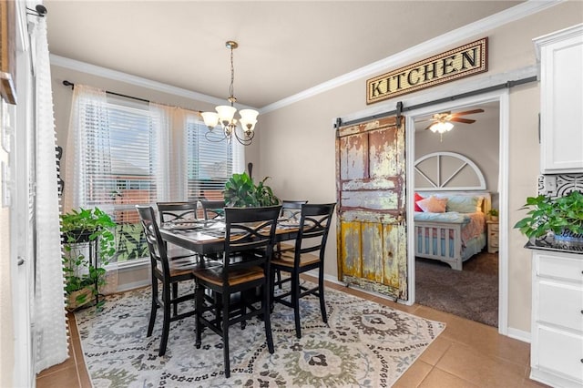 dining space with a barn door, baseboards, light tile patterned flooring, crown molding, and ceiling fan with notable chandelier