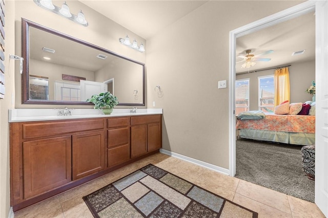 bathroom featuring tile patterned floors, visible vents, a sink, and ensuite bathroom