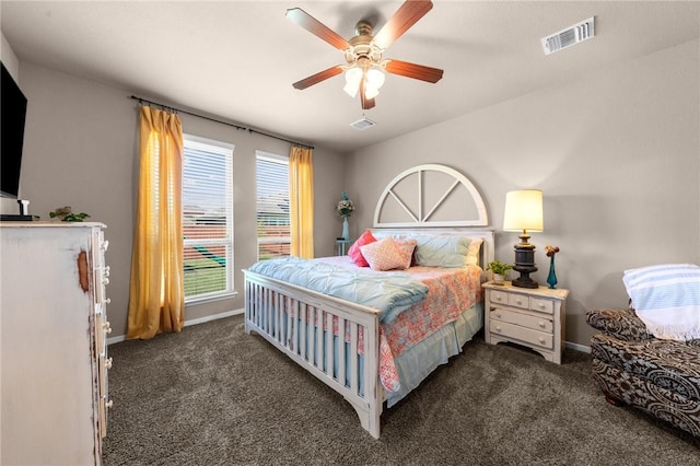 bedroom with a ceiling fan, dark colored carpet, visible vents, and baseboards