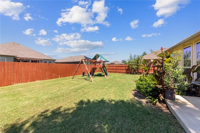 view of yard featuring a playground and a fenced backyard