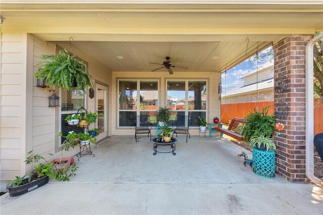 view of patio with fence and a ceiling fan