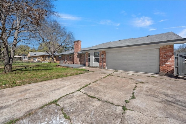 view of front of property with a garage and a front lawn