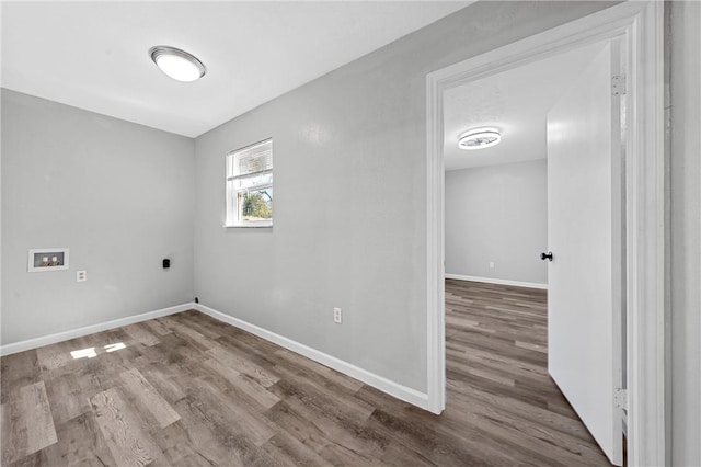 laundry area with washer hookup, electric dryer hookup, and wood-type flooring