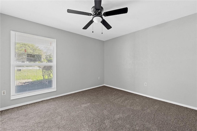 carpeted spare room featuring ceiling fan