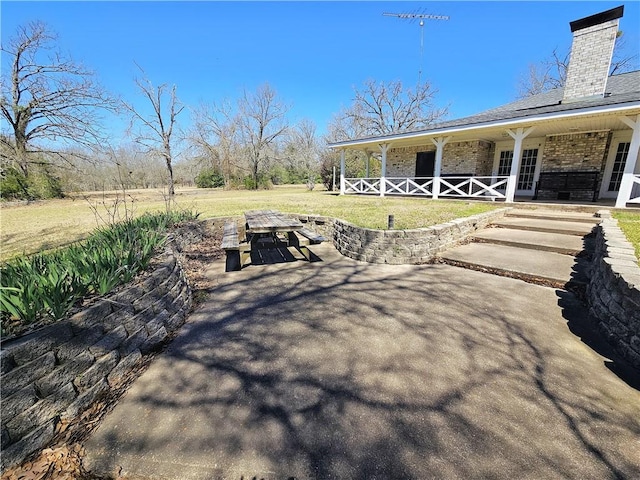 view of yard featuring covered porch