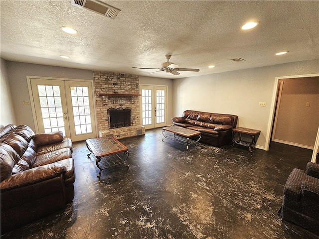 living room featuring a fireplace, french doors, and visible vents