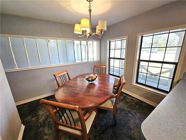 dining space featuring an inviting chandelier and baseboards