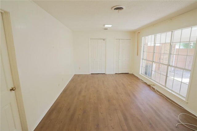 spare room with light hardwood / wood-style flooring