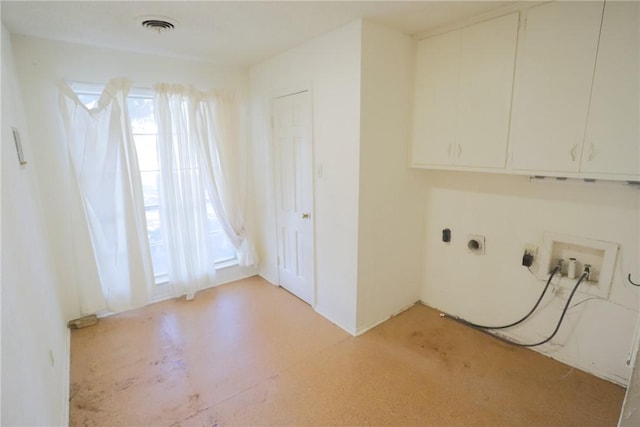 clothes washing area featuring cabinets, washer hookup, a wealth of natural light, and electric dryer hookup